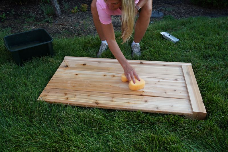 Hand-finishing a reclaimed timber panel with oil